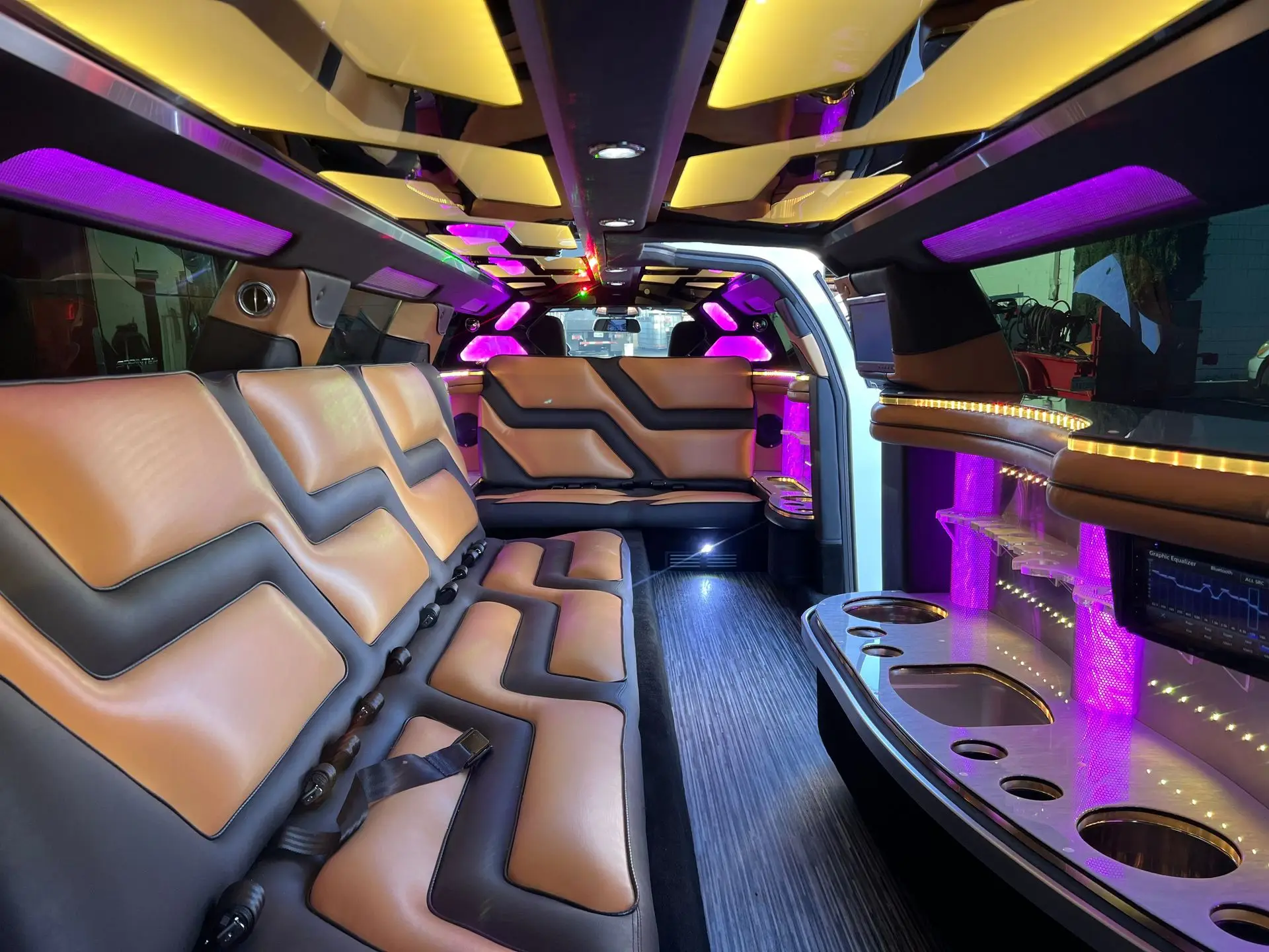 Interior view of Dodge Charger Stretch Limousine with leather seating, LED lighting, and luxury bar setup – Basking Ridge Limousine Services