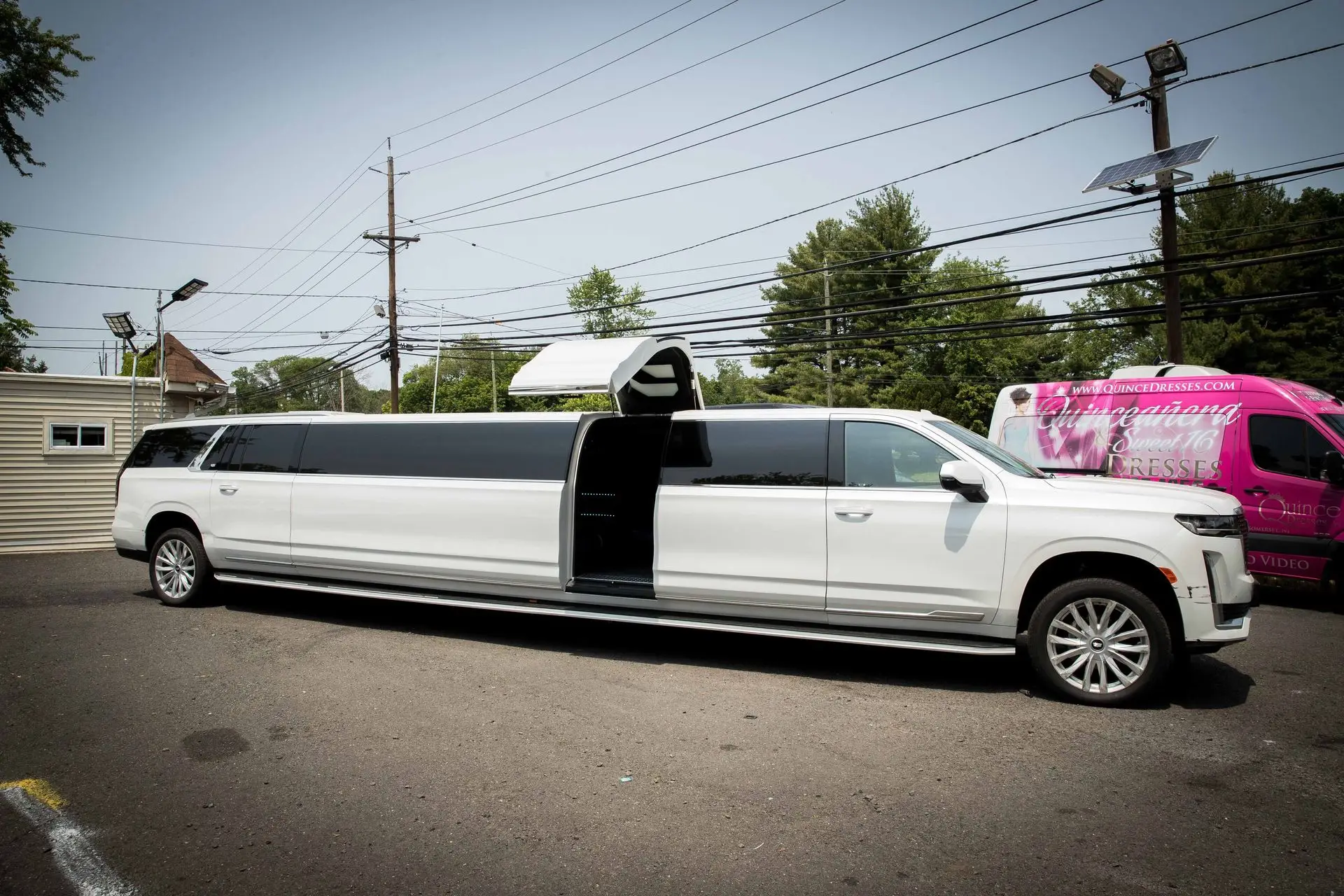 2024 Cadillac Escalade Stretch Limousine with vertical jet door open, parked at Basking Ridge Limousine Services in New Jersey.