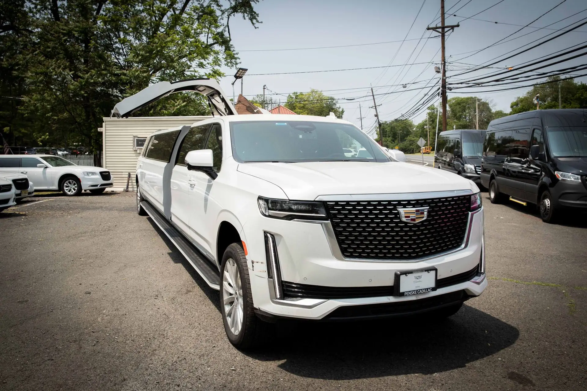 Luxury 2024 Cadillac Escalade Stretch Limousine with vertical jet door open, offered by Basking Ridge Limousine Services.