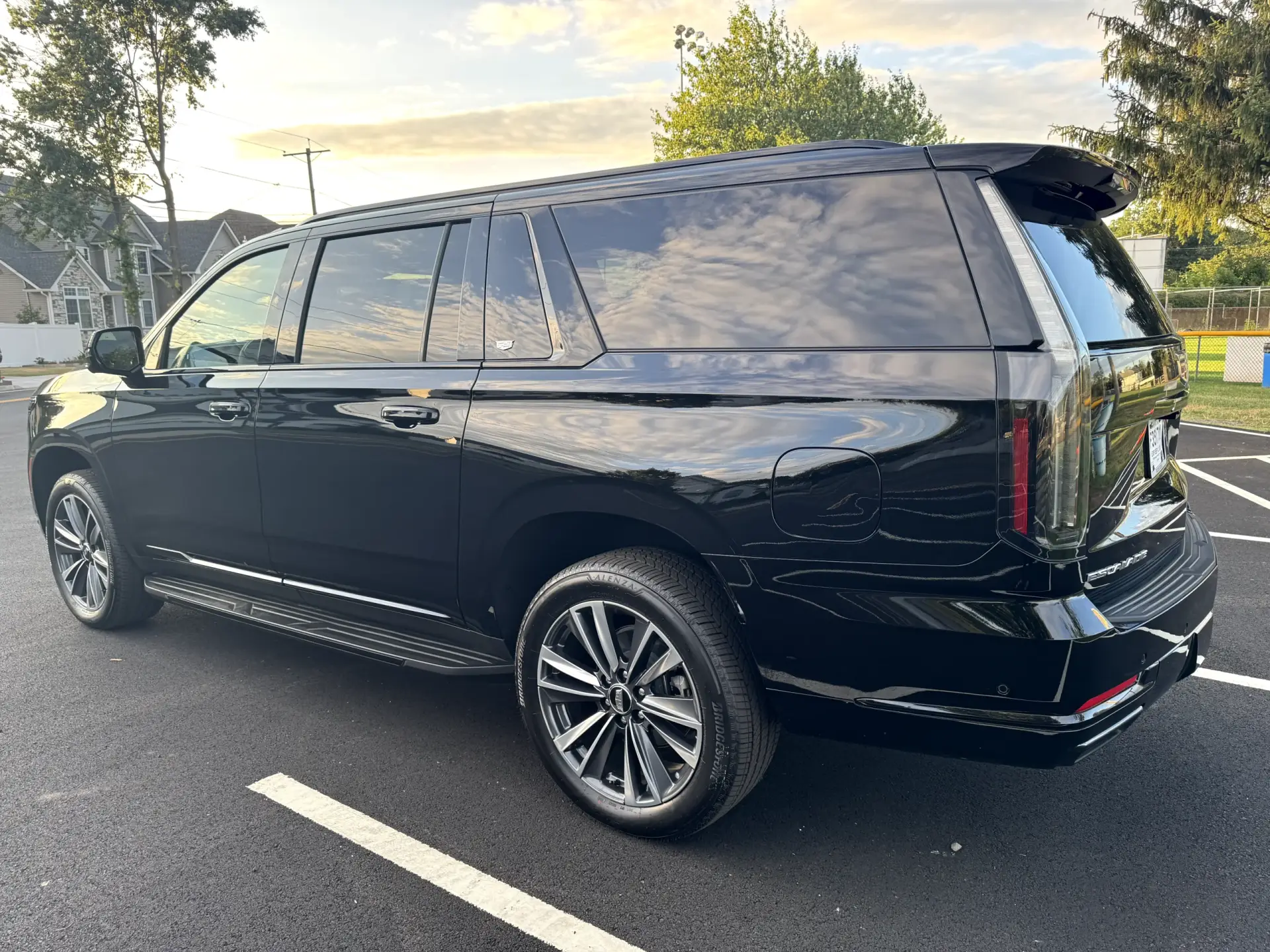 Luxury black 2025 Cadillac Escalade Platinum SUV rear-side view parked in New Jersey — elegant and polished premium vehicle by Basking Ridge Limousine Services.