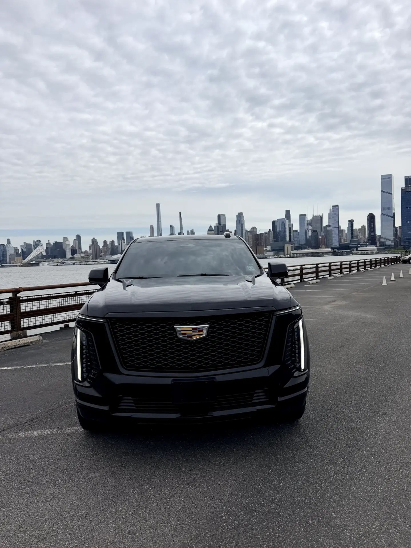 Gleaming black 2025 Cadillac Escalade luxury SUV at night professional chauffeur service New Jersey Basking Ridge Limousine Services