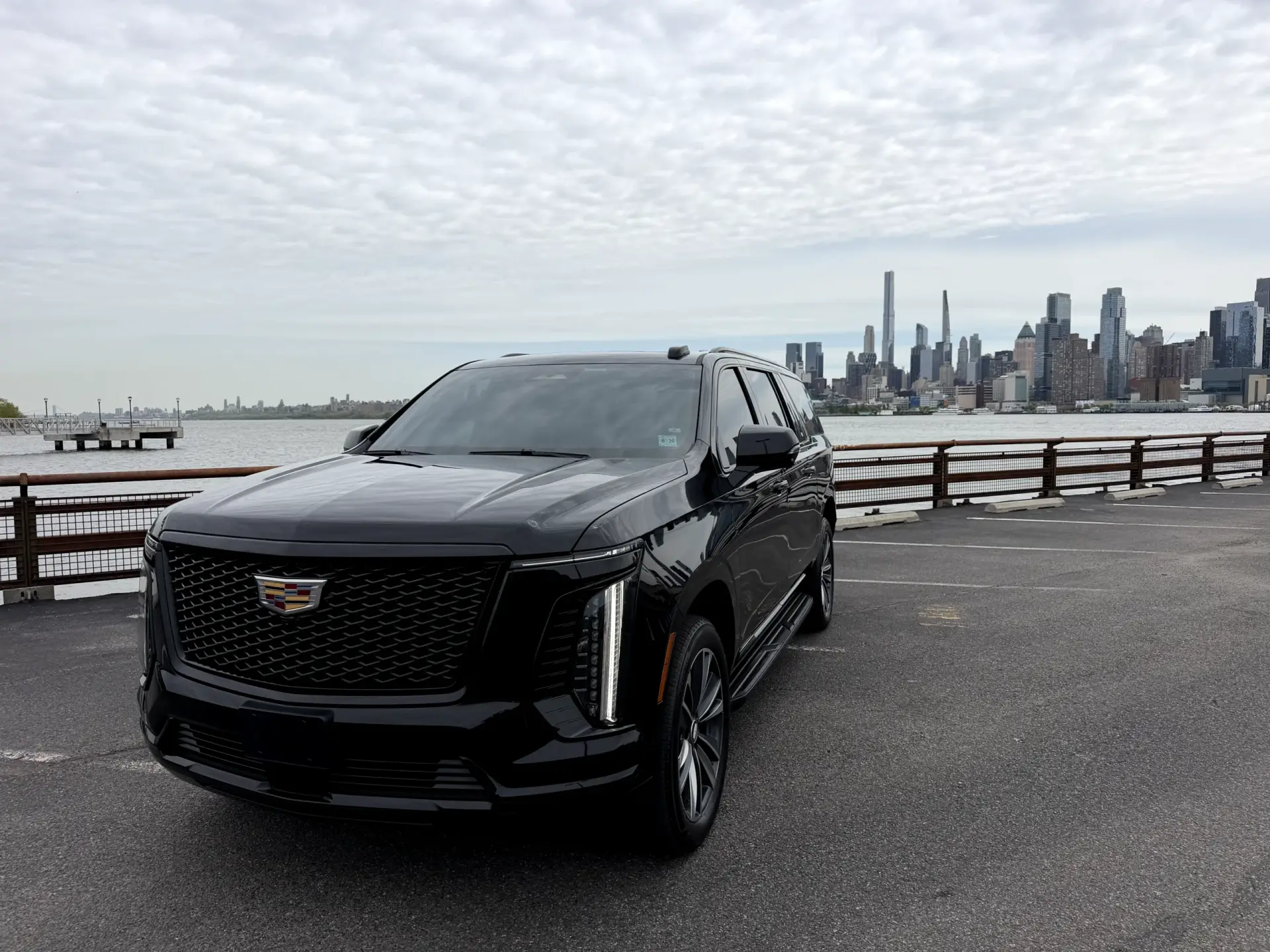 2025 Cadillac Escalade Platinum SUV chauffeur service with NYC skyline backdrop by Basking Ridge Limousine Services New Jersey