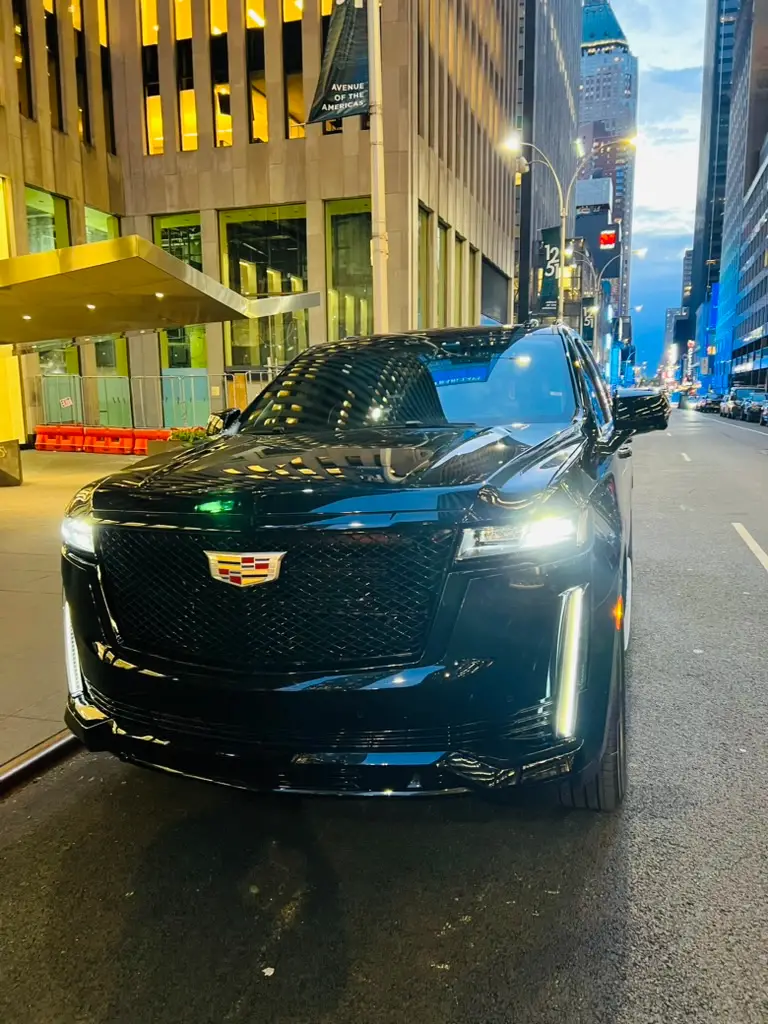 Chauffeured Cadillac Escalade luxury SUV on Avenue of the Americas in Manhattan — NYC city tour and night out limousine service by Basking Ridge Limousine