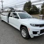 White 2024 Jeep Grand Cherokee stretch limo front exterior with passenger door open