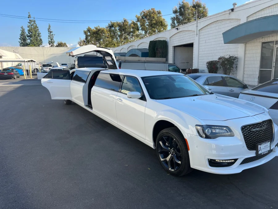 White Chrysler 300 stretch limousine with passenger doors open