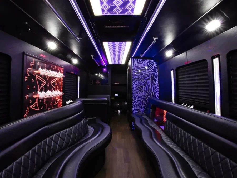 Interior of 25-passenger party bus with black leather seating and LED lighting