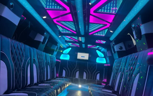 Vibrant interior of Basking Ridge Limousine’s 2025 GMC Yukon Stretch Limo with LED-lit ceiling, premium leather seats, and modern ambiance lighting.