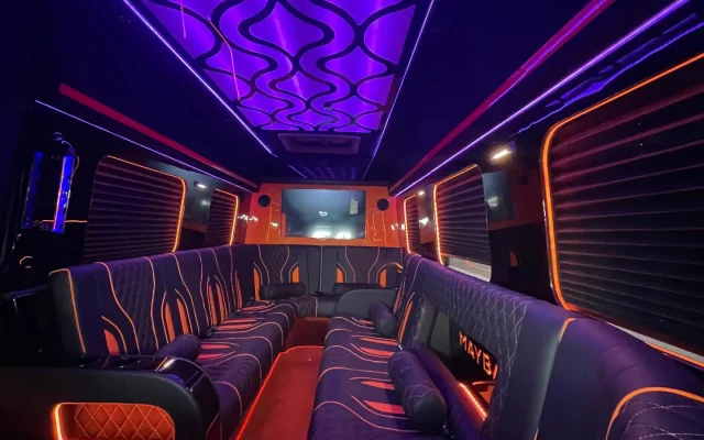 Full interior cabin of 2025 Mercedes Sprinter Maybach limo party bus showing purple-blue wave LED ceiling, Maybach-branded leather seating, orange accent lighting, and LCD screen — Basking Ridge Limousine NJ