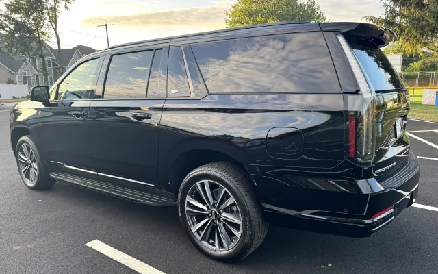 Luxury black 2025 Cadillac Escalade Platinum SUV rear-side view parked in New Jersey — elegant and polished premium vehicle by Basking Ridge Limousine Services.