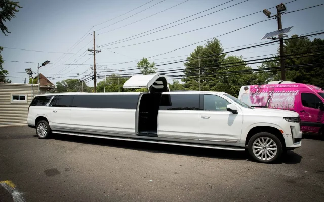 2024 Cadillac Escalade Stretch Limousine with vertical jet door open, parked at Basking Ridge Limousine Services in New Jersey.