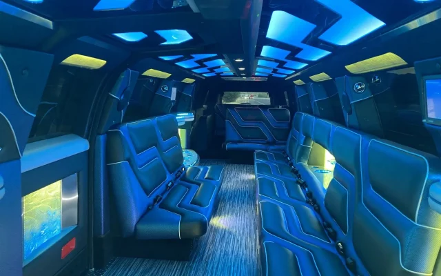 Interior of 2024 Cadillac Escalade Stretch Limousine with ambient LED lighting, luxury leather seating, and entertainment features by Basking Ridge Limousine Services.